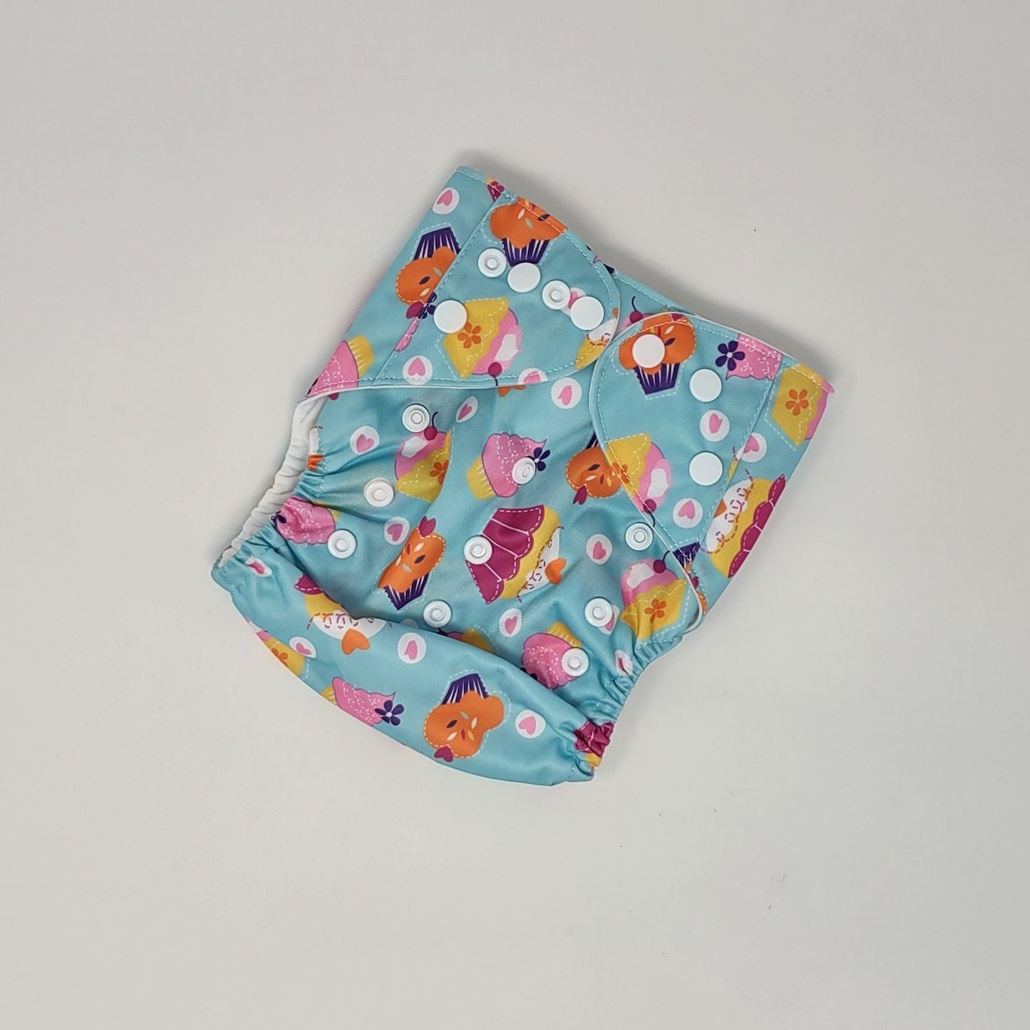 cute cupcakes on blue background cloth diaper with adjustable snaps